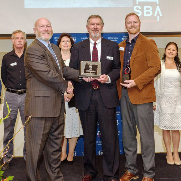 2019 SBDC Excellence and Innovation Award Winners of the 2019 SBDC Excellence and Innovation Award being given their trophies